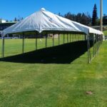 Framed Marquee Pole and roof section setup on a field